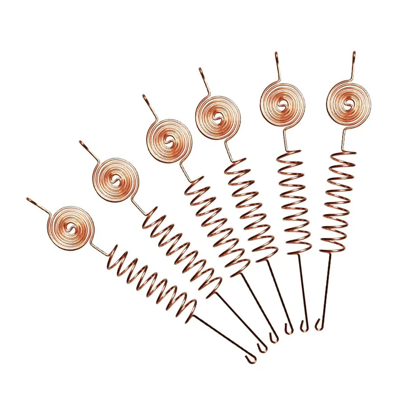 Six copper Tesla Coil antennas fanned out on white, showing spiral heads, sprung middles and straight lower stakes